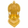 A small brass Kamatchi vilakku (lamp) with intricate traditional design, polished to a shine.