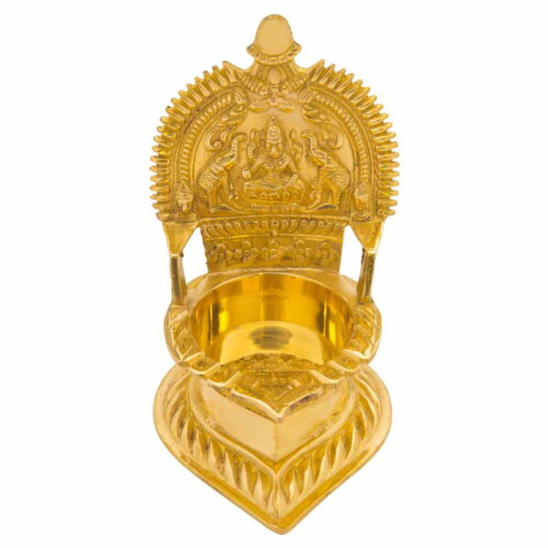 A small brass Kamatchi vilakku (lamp) with intricate traditional design, polished to a shine.