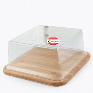 A wooden cake stand topped with an acrylic cover, showcasing a dessert inside.