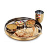 A set of stainless steel Thali plates with a brass coating, combining durability with a traditional look.