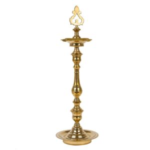 A traditional brass Kuthu Vilakku (lamp) with intricate designs, used for religious and decorative purposes.